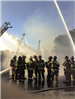 Fire fighters spraying water